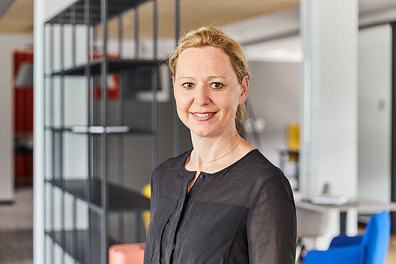 Portrait of Bernadette Atzinger, smiling friendly into the camera.