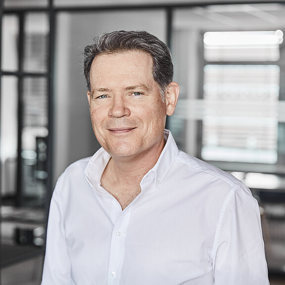 Portrait von Sven Schwotzer, der freundlich in die Kamera schaut.